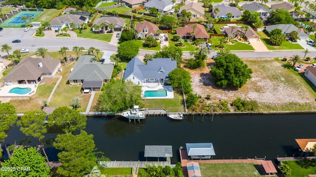 birds eye view of property with a water view and a residential view