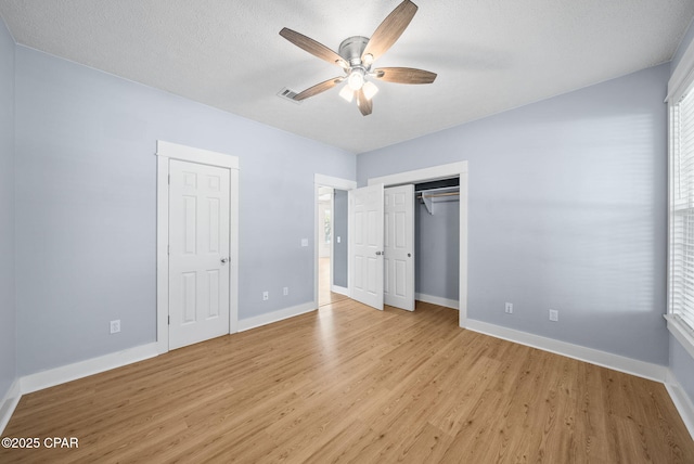 unfurnished bedroom with light wood finished floors, baseboards, and a ceiling fan