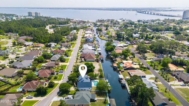 drone / aerial view with a water view and a residential view