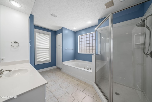 bathroom with a stall shower, vanity, visible vents, and a bath
