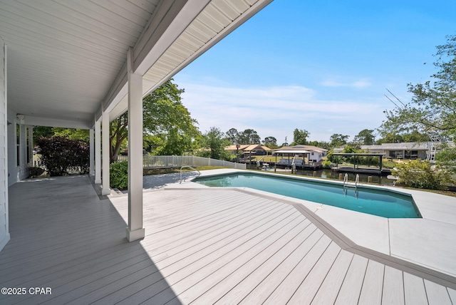 view of pool with a water view, fence, and a fenced in pool