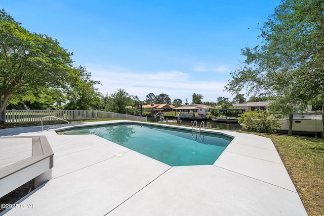 view of pool with a water view, fence, a patio, and a fenced in pool