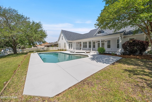 view of pool with a yard, a patio area, a fenced in pool, and fence