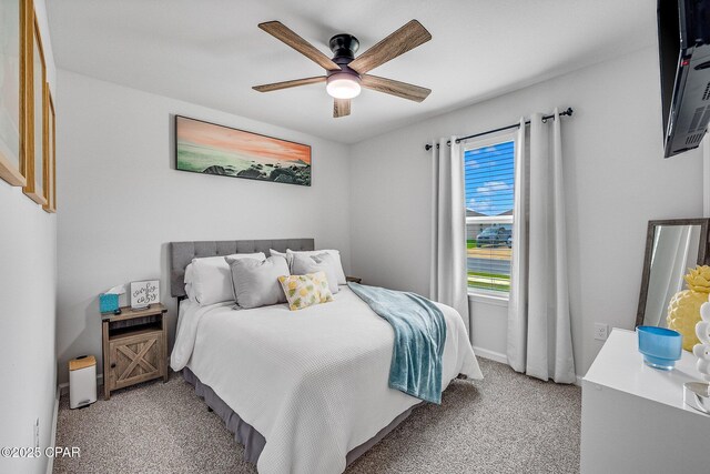 bedroom with ceiling fan, light colored carpet, and baseboards