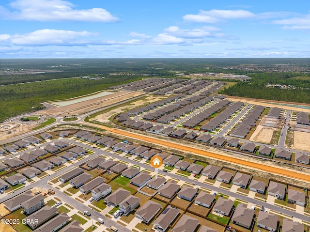 drone / aerial view featuring a residential view and a forest view