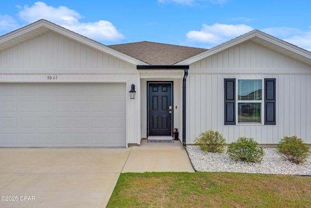 ranch-style house featuring roof with shingles, concrete driveway, and a garage