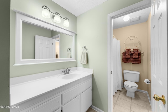 bathroom with toilet, tile patterned floors, a textured ceiling, and vanity
