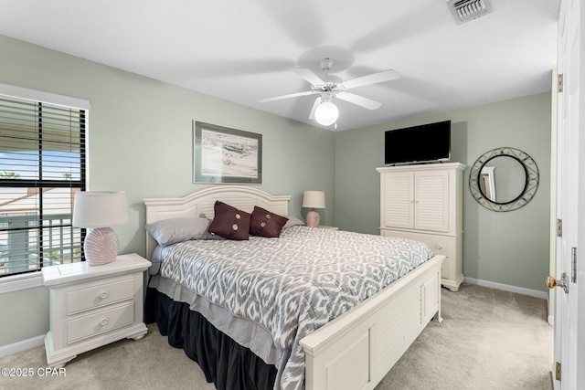 bedroom with visible vents, ceiling fan, light colored carpet, and baseboards