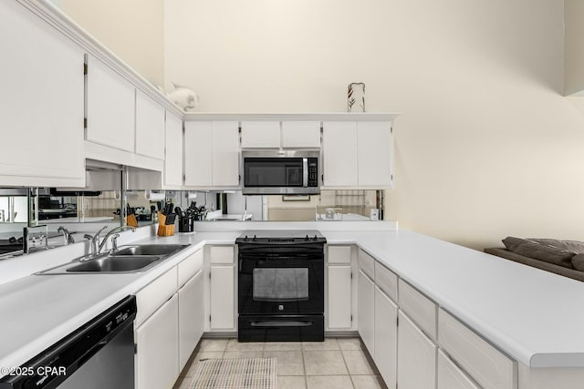 kitchen featuring light tile patterned floors, a sink, stainless steel appliances, light countertops, and a peninsula
