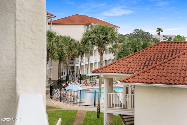 community pool with a patio and fence