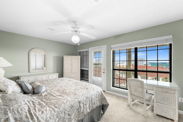 bedroom featuring light colored carpet, visible vents, baseboards, and multiple windows
