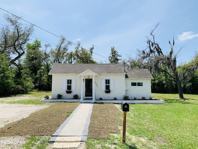 1003 E 8th St, Lynn Haven, FL 32444 - view of front of house with a front lawn and roof with shingles