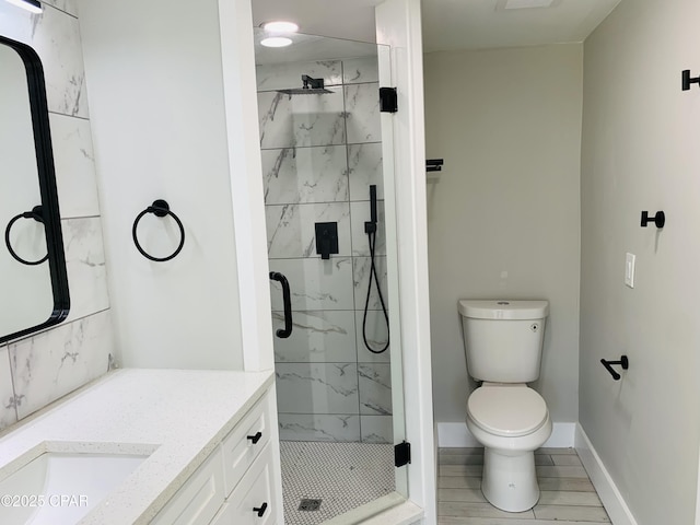 1003 E 8th St, Lynn Haven, FL 32444 - bathroom featuring toilet, a marble finish shower, vanity, and baseboards