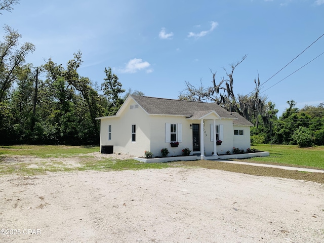 1003 E 8th St, Lynn Haven, FL 32444 - view of front of house with a front lawn, stucco siding, and roof with shingles