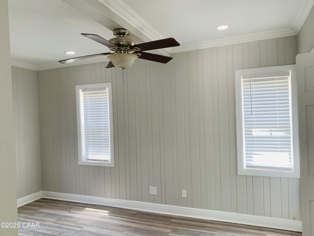 1003 E 8th St, Lynn Haven, FL 32444 - empty room featuring crown molding, ceiling fan, a healthy amount of sunlight, baseboards, and wood finished floors