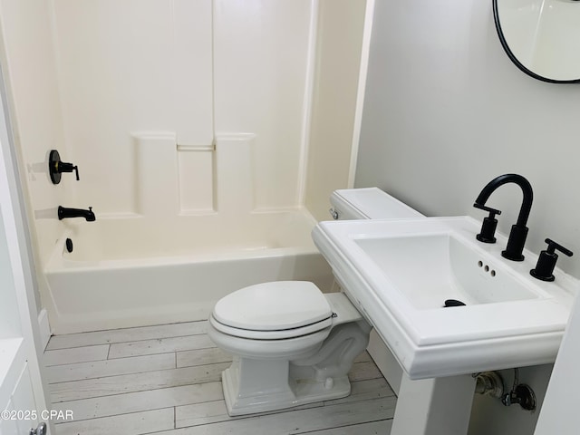 1003 E 8th St, Lynn Haven, FL 32444 - bathroom featuring toilet, a sink, bathing tub / shower combination, and wood finished floors