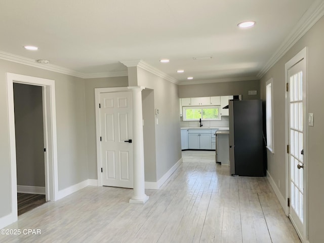 1003 E 8th St, Lynn Haven, FL 32444 - kitchen featuring light countertops, baseboards, freestanding refrigerator, and a sink