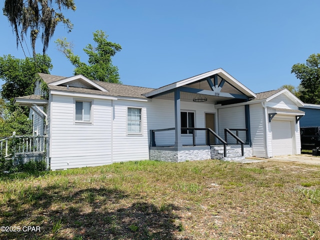 308 S Macarthur Ave, Panama City, FL 32401 - single story home with an attached garage, a shingled roof, a front lawn, and driveway