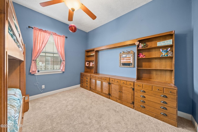 bedroom with baseboards, a textured ceiling, carpet, and ceiling fan
