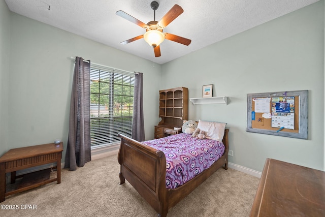 bedroom featuring carpet floors, a textured ceiling, and ceiling fan