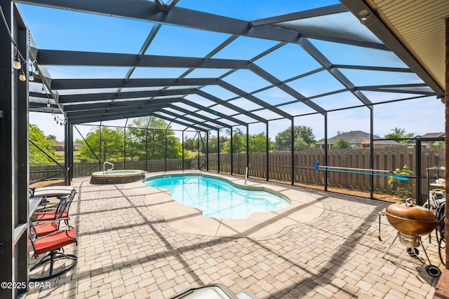 view of pool featuring a fenced backyard, a patio, a pool with connected hot tub, and a grill