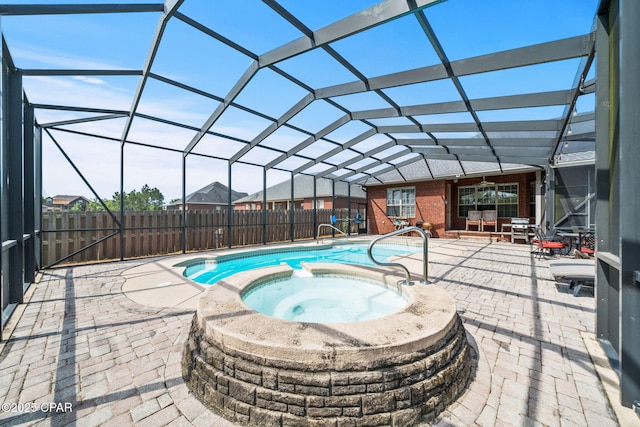view of swimming pool featuring a lanai, a patio area, a pool with connected hot tub, and fence