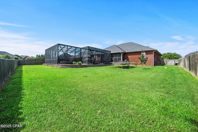 view of yard with a fenced backyard and a trampoline