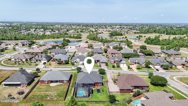 drone / aerial view featuring a water view and a residential view