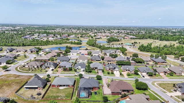birds eye view of property with a water view and a residential view