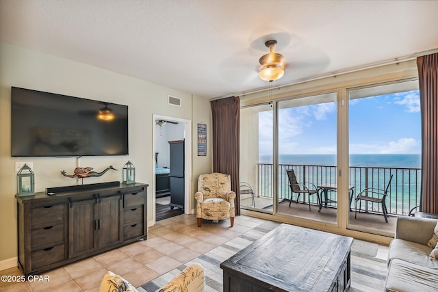 9900 S Thomas Dr Unit 1418, Panama City Beach, FL 32408 - living area featuring light tile patterned floors, ceiling fan, a water view, and visible vents