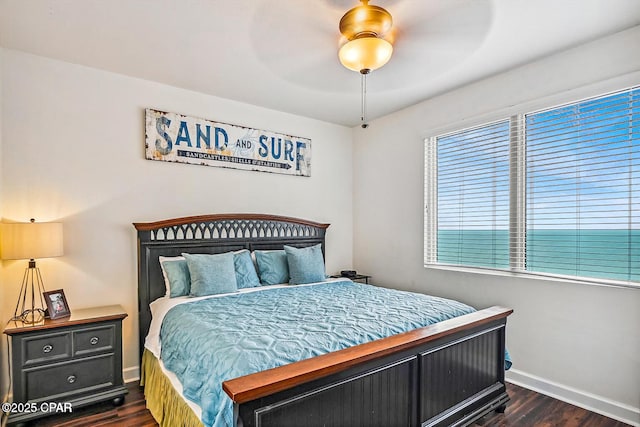 9900 S Thomas Dr Unit 1418, Panama City Beach, FL 32408 - bedroom featuring ceiling fan, dark wood finished floors, and baseboards