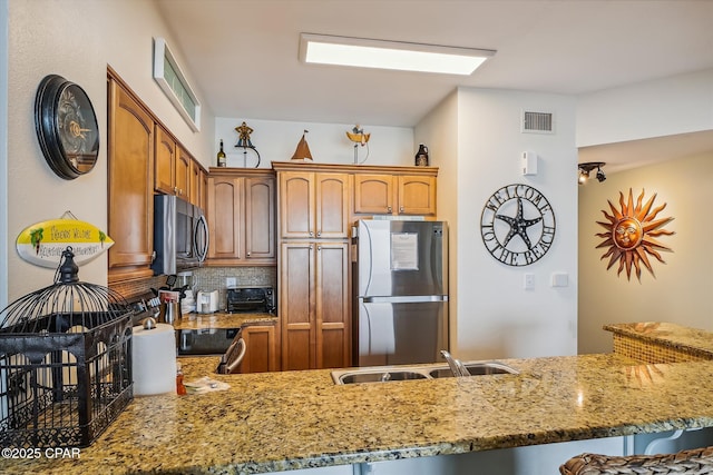 9900 S Thomas Dr Unit 1418, Panama City Beach, FL 32408 - kitchen featuring a sink, visible vents, stainless steel appliances, light stone countertops, and backsplash
