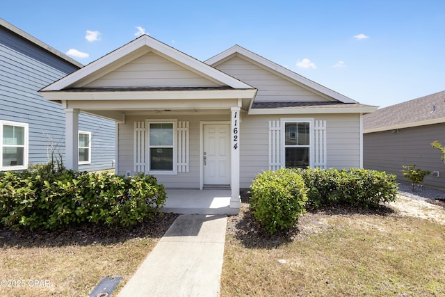 view of front of property with a porch and a front yard