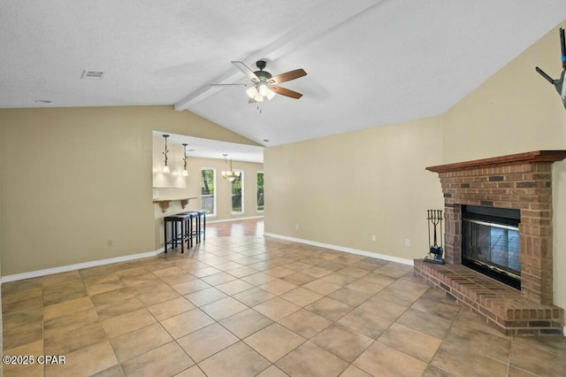 unfurnished living room with lofted ceiling with beams, ceiling fan with notable chandelier, a brick fireplace, visible vents, and light tile patterned flooring