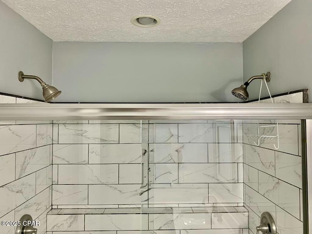 full bathroom with a textured ceiling and tiled shower / bath