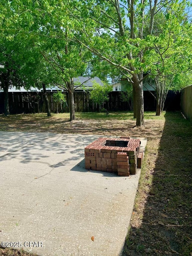 view of patio / terrace with a fire pit and a fenced backyard