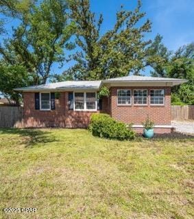 111 N Marie Dr, Panama City, FL 32401 - ranch-style house featuring brick siding, fence, and a front lawn