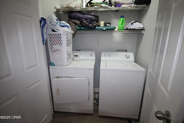 laundry area with washing machine and clothes dryer, dark wood-style floors, and laundry area