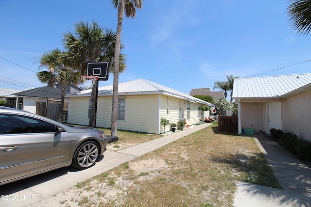 view of home's exterior with fence and metal roof