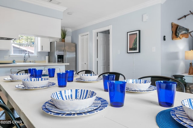 dining space with ornamental molding