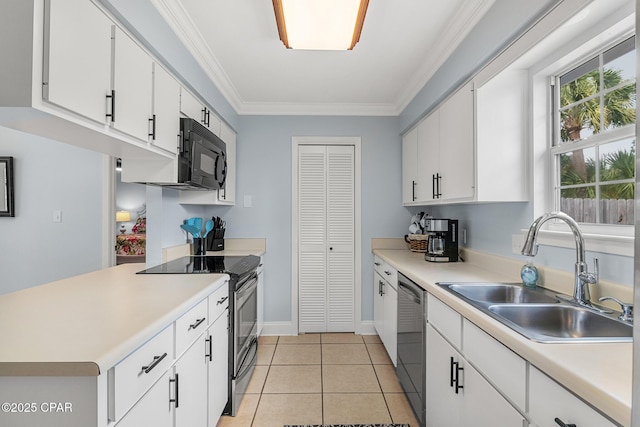kitchen with white cabinets, appliances with stainless steel finishes, light countertops, and a sink