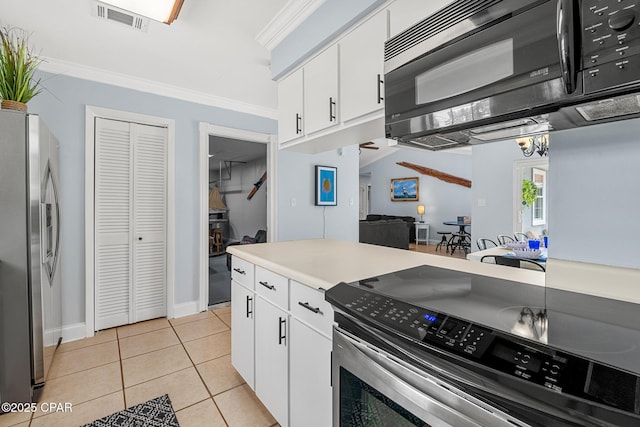 kitchen with white cabinetry, appliances with stainless steel finishes, visible vents, light tile patterned flooring, and ornamental molding