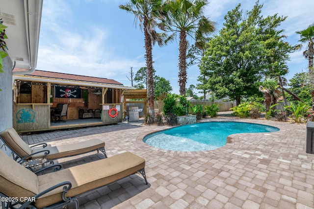 view of swimming pool featuring a patio, a fenced backyard, and a fenced in pool