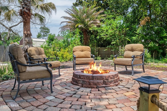 view of patio featuring fence and an outdoor fire pit