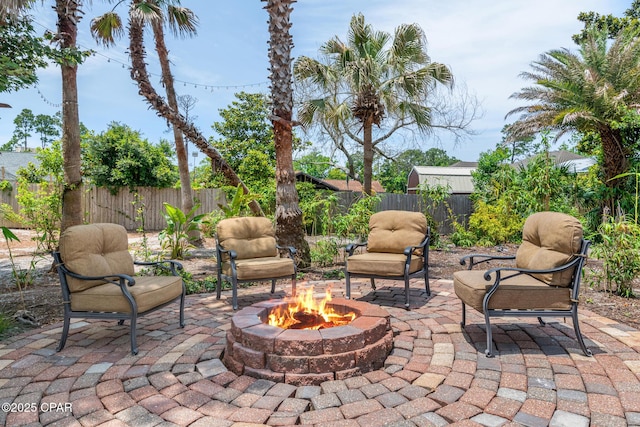 view of patio / terrace with an outdoor fire pit and a fenced backyard