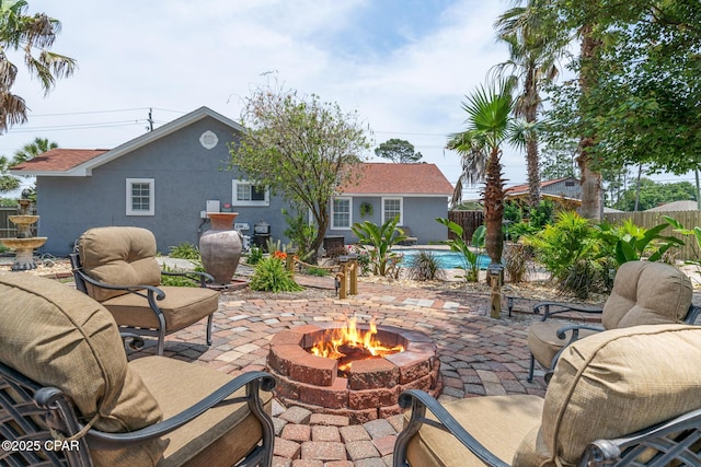 view of patio / terrace with an outdoor pool, an outdoor fire pit, and fence private yard