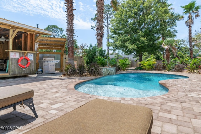 view of swimming pool with a fenced in pool, grilling area, a patio area, and a fenced backyard