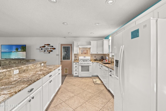 kitchen with a textured ceiling, visible vents, a sink, white appliances, and white cabinetry
