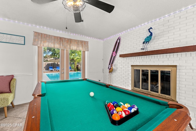 recreation room with billiards, ceiling fan, and a textured ceiling