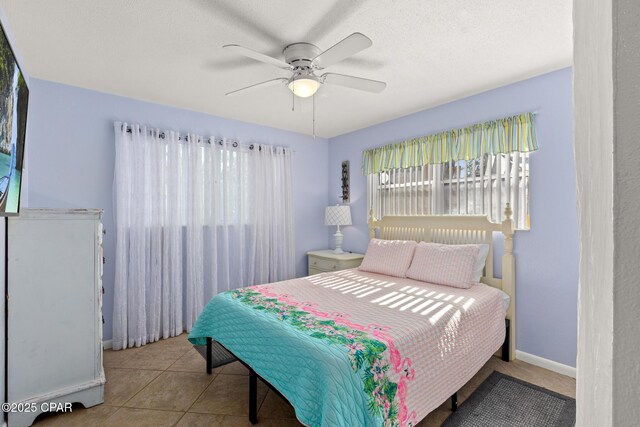 bedroom with baseboards and ceiling fan